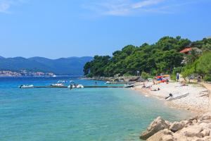 a group of people on a beach near the water at Seaside holiday house Orebic, Peljesac - 23750 in Orebić +7 photos