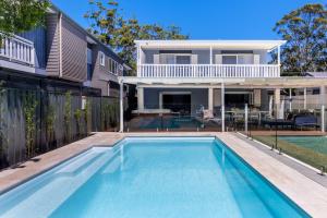 a swimming pool in the backyard of a house at 35 South - Pet Friendly Beach House with Pool, Spa in Vincentia