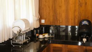 a kitchen with a black counter top and a sink at Villa Gubug Ijen Banyuwangi in Mantaak