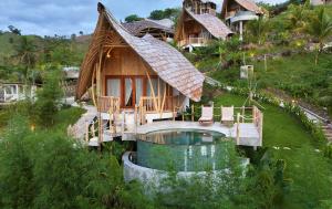 a resort with a tub in front of a house at Green Poya - Luxury Eco Bambu Resort in South Lombok in Selong Belanak