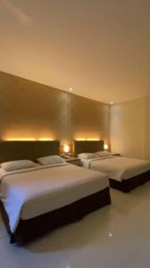 Ένα ή περισσότερα κρεβάτια σε δωμάτιο στο Grand Q Hotel Gorontalo +10 φωτογραφίες