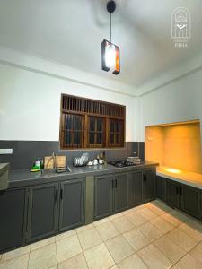 a kitchen with gray cabinets and a counter top at Villas by DIMA in Galle