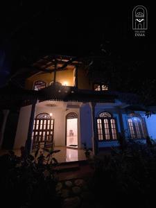 a house at night with the lights on at Villas by DIMA in Galle