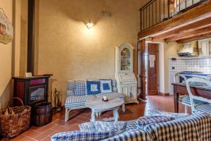 a living room with couches and a table and a fireplace at Agriturismo Podere Campiglia in Pian di Scò