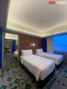 Ένα ή περισσότερα κρεβάτια σε δωμάτιο στο Grand Q Hotel Gorontalo