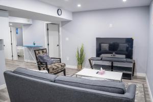a living room with a couch and a piano at Beautiful Brand New 1BR Suite with Private Entrance and free on-site parking in Winnipeg