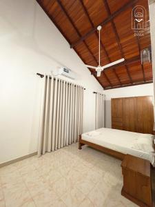 a bedroom with a bed and a wooden ceiling at Villas by DIMA in Galle