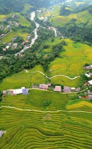 an aerial view of a farm in a field at Homestay Quyền Linh-Tour Tây Côn Lĩnh in Kon Rung (1)
