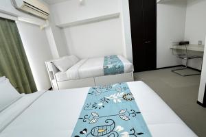 a small bedroom with a bed and a couch at LIO HOTEL Tokyo Nippori in Tokyo +26 photos