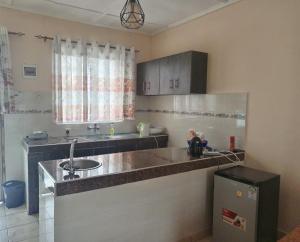 a kitchen with a sink and a counter top at Swahili home stay in Mombasa