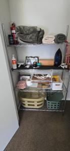 a shelf in a room with items on it at Chestnut Bay Country Retreat in Whakamarama +11 photos