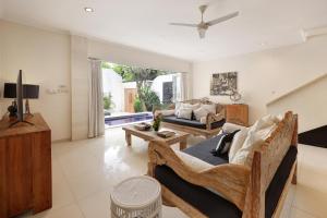 a living room with a couch and a table at Villa Alba in Seminyak