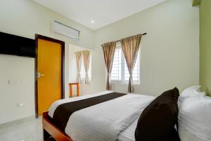 Ένα ή περισσότερα κρεβάτια σε δωμάτιο στο Townhouse Svb Tech Park Kalapatti Formerly RG Stays