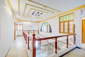 a staircase in a house with a ceiling at Hotel O Tiara Grand in Chennai
