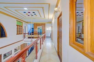 a hallway with a staircase and a ceiling at Hotel O Tiara Grand in Chennai
