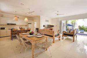 a kitchen and living room with a table and chairs at Villa Alba in Seminyak
