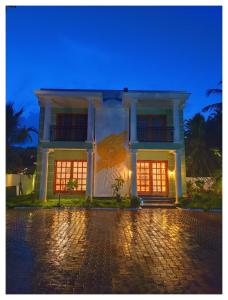 a building with a painting on the side of it at Le French Nest in Puducherry