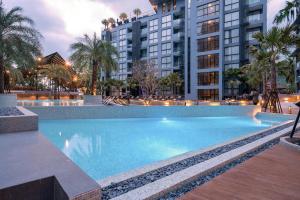 a large swimming pool in front of some buildings at Wellness Hub 2BR Pool View - CTG B503-4 in Kamala Beach