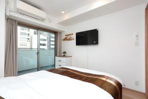 Televiisor ja/või meelelahutuskeskus majutusasutuses 中央公馆 Central Mansions 地下鉄谷町六丁目徒步1分心斎橋駅天王寺駅まで電車1本