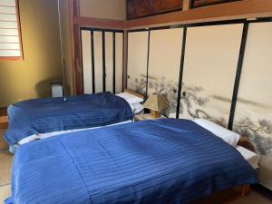 Ένα ή περισσότερα κρεβάτια σε δωμάτιο στο 和の家 縁en 白馬へアクセス良好