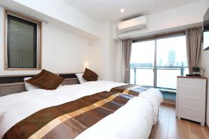 Voodi või voodid majutusasutuse 中央公馆 Central Mansions 地下鉄谷町六丁目徒步1分心斎橋駅天王寺駅まで電車1本 toas