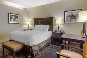 a hotel room with a large bed and a desk at Best Western Frontier Motel in Lone Pine +149 photos