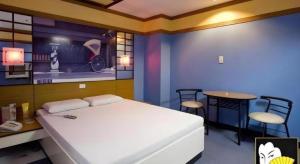 a bedroom with a bed and a table and chairs at Hotel Sogo Mexico Pampanga in Lagundi +36 photos