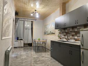 a kitchen with a counter and a table in it at River-Side in Dilijan