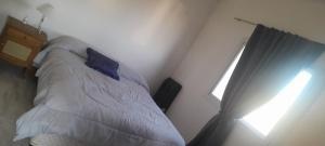 a bedroom with a bed and a window at Namaste in Olavarría +5 photos