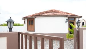 a small house with a gate and a fence at Aqua Dream Water Park in Bhuj +5 photos