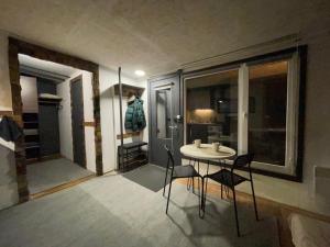 a dining room with a table and chairs in a room at Scandinavia bungalow in Kamennaya Gora +13 photos