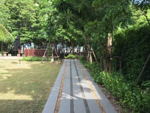 a walkway in a park with trees and grass at Avatar Railay in Railay Beach