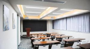 a classroom with wooden desks and a chalkboard and a classroom at Jinjiang Inn Select Xi'an Dayan Tower Zhuque Street Chengshi Lifang in Xi'an