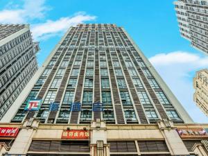 a tall building with windows on the side of it at PAI Hotels·Jiangbei Airport Central Park in Chongqing