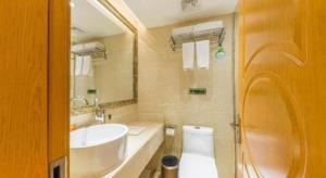 a bathroom with a sink and a toilet and a mirror at Vienna Hotel Inner Mongolia Hohhot Railway Station Gongzhufu Metro Station in Hohhot +64 photos