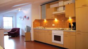 a kitchen with a sink and a stove at Landhaus Suntheim in Wertach