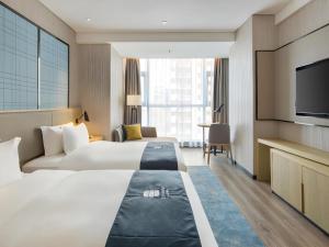 Ένα ή περισσότερα κρεβάτια σε δωμάτιο στο Echarm Hotel Changsha Gaoqiao