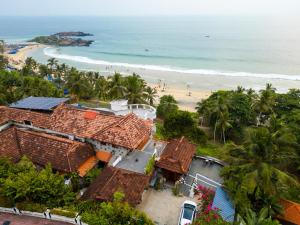 an aerial view of a beach with houses and the ocean at By The Bay Kovalam in Trivandrum
