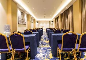 a conference room with blue tables and chairs at City Comfort Inn Nanning Taoyuan Road in Nanning