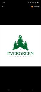 a logo with trees on top of a house at Evergreen Homestay in Dwarka