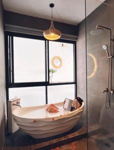 a large bath tub in a bathroom with a window at Villa Jasmine in Seminyak