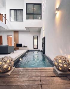a swimming pool in the middle of a house at Villa Jasmine in Seminyak