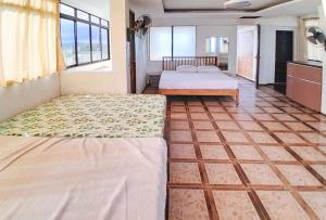 Ένα ή περισσότερα κρεβάτια σε δωμάτιο στο Balay Baybay Roxas