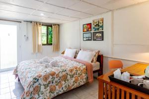 a hotel room with a bed and a chair at Panpurie Koh Lanta Resort - 2-Minute Walk to the Beach in Ko Lanta Yai