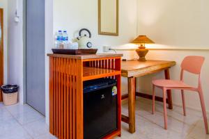 a kitchen with a wooden table and a dishwasher at Panpurie Koh Lanta Resort - 2-Minute Walk to the Beach in Ko Lanta Yai