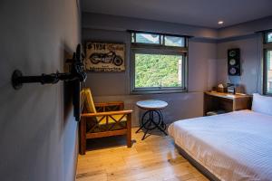 Ένα ή περισσότερα κρεβάτια σε δωμάτιο στο Jiufen HappyLand B&B