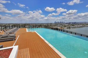 a large swimming pool on the roof of a building at Riverside Modern Living 2B2B Apt with Parking in Brisbane