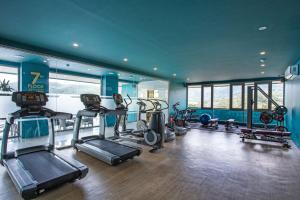 a gym with several treadmills and machines in a room at Studio Apt Seaview Balcony - Oceana C63 in Kamala Beach