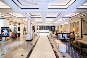 a lobby with couches and couches in a building at The All New Stark Boutique Hotel in Kuta