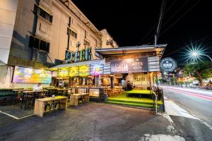 a restaurant on the side of a street at night at The All New Stark Boutique Hotel in Kuta